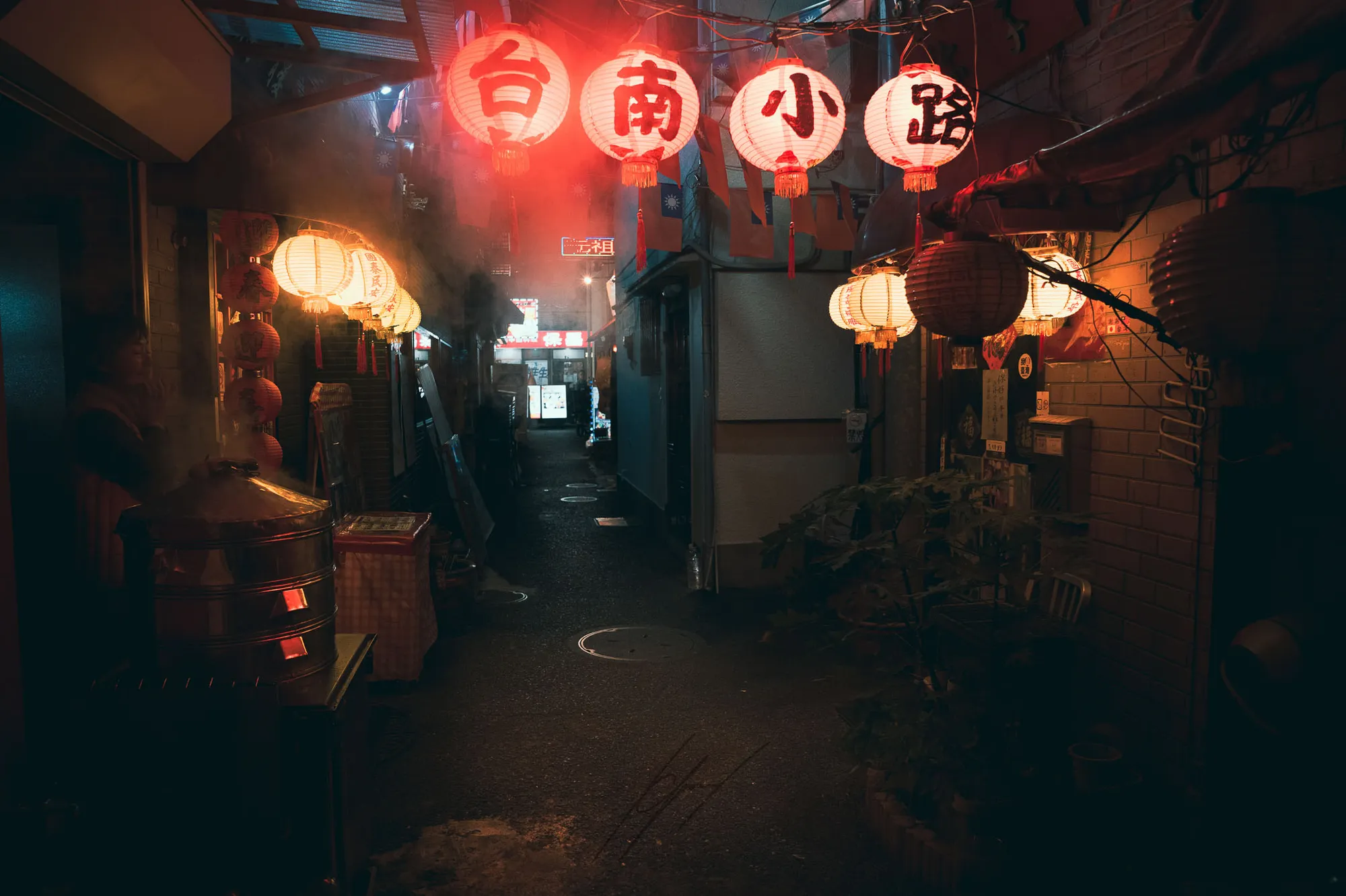 A lantern-lit alley with rising steam, Yokohama.