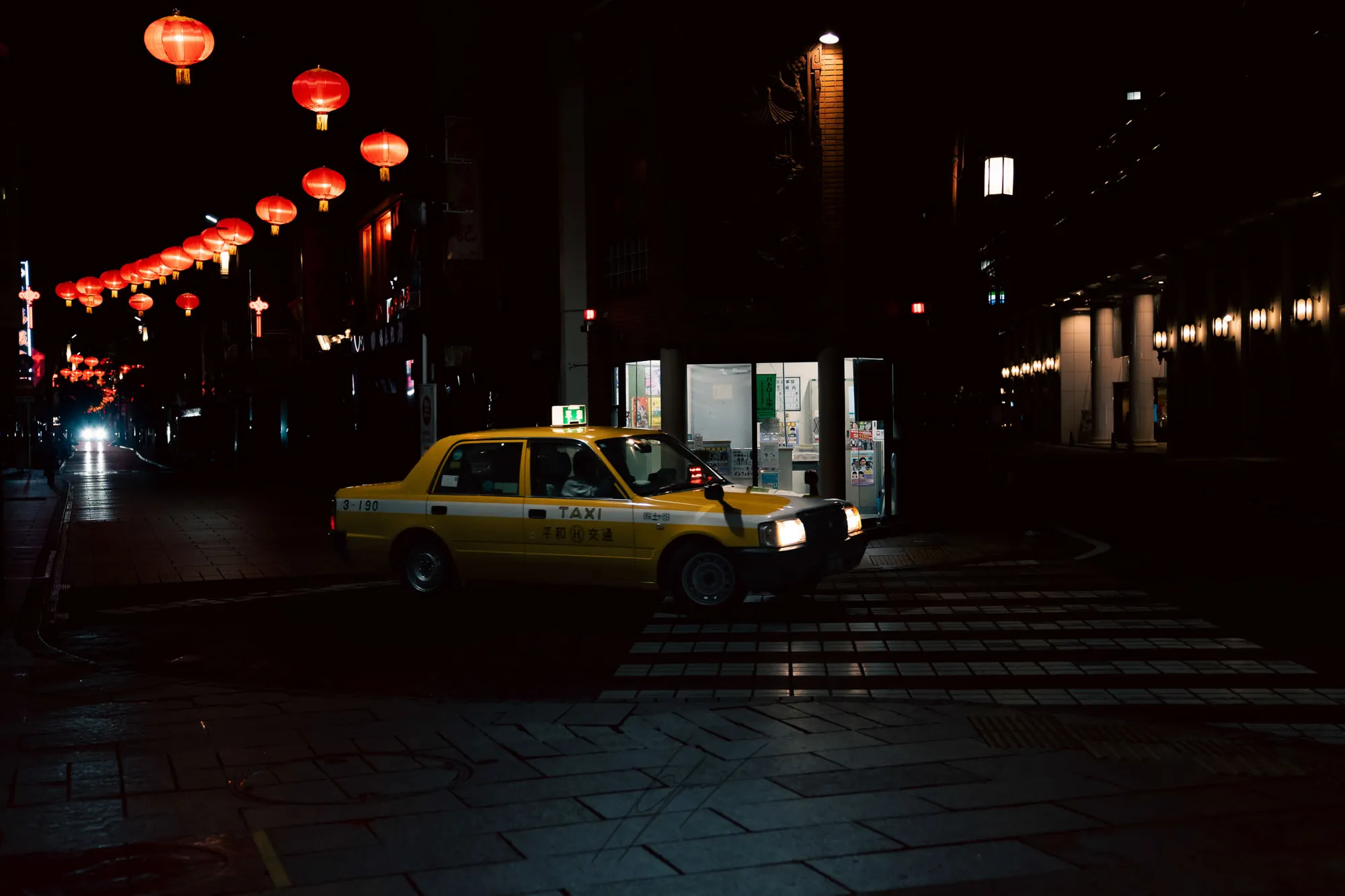 A taxi on a cinematic Yokohama street at night.